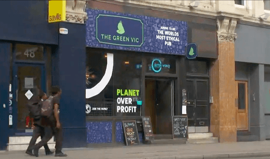 A video thumbnail showing the exterior storefront of The Green Vic pub featuring a planet over profit window display as broadcast on Dutch national news