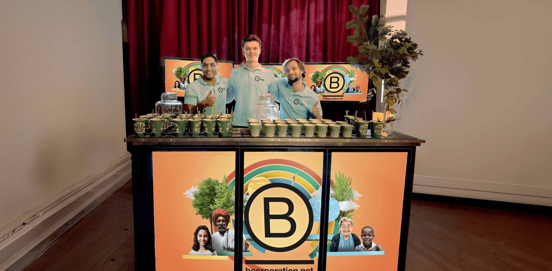 The BetterWorld team behind their B Corp branded digital mobile bar at a corporate event