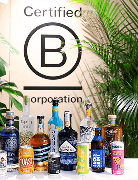 A premium selection of sustainable spirits craft beer and organic soft drinks displayed in front of a Certified B Corporation sign representing our fully certified ethical drinks menu