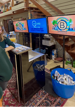 A premium digital mobile bar setup with three immersive screens displaying custom Certified B Corporation branding at the Kent B Corp birthday event