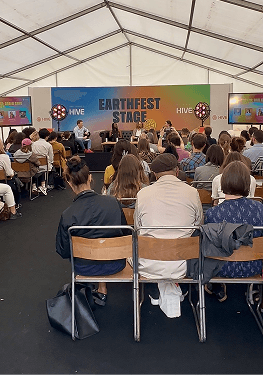 Guests gathered in the Earthfest marquee listening to the climate action speakers