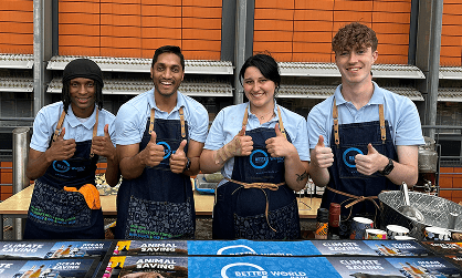 Four smiling team members raising fresh cocktails behind a corporate event bar representing our social impact employment mission providing opportunities for vulnerable people and ex offenders